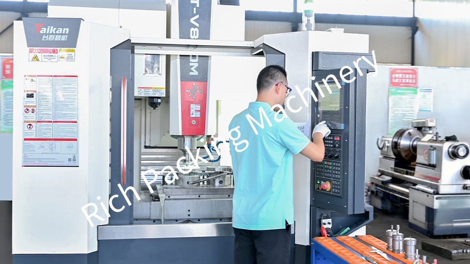 An engineer is machining a tablet press turret using CNC equipment